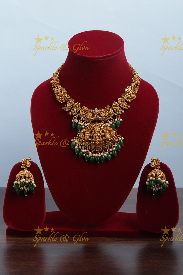 Intricately Carved Gold Alike Polished Lakshmi Elephant Short Necklace With Green Beads