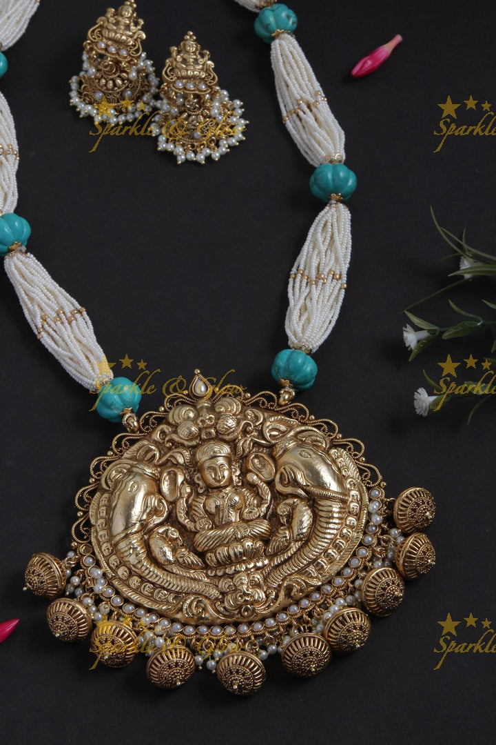 Beautiful Gold Alike bead necklace with intricately carved lakshmi ganesh pendent
