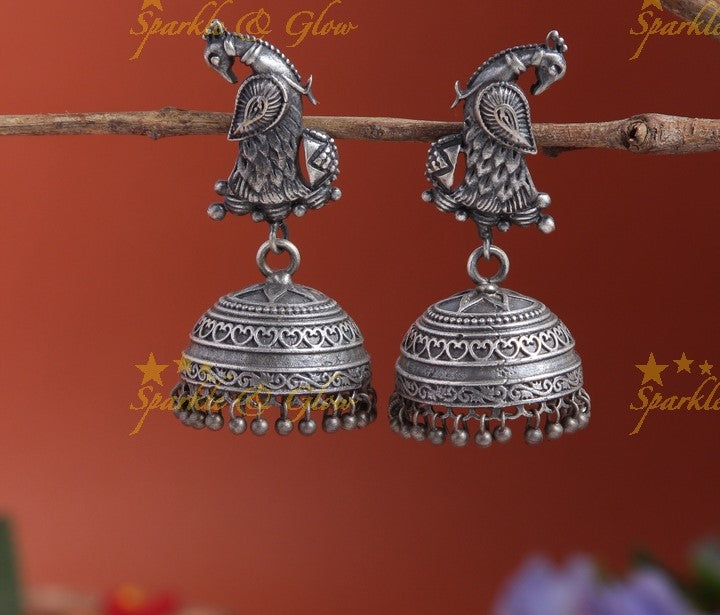 Charming Silver look alike peacock studded jhumkas