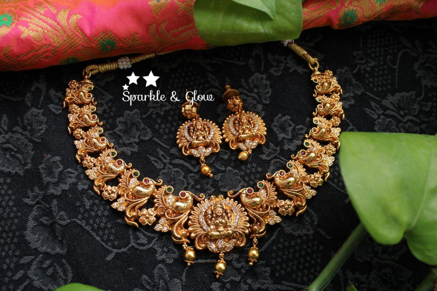 Gold alike polished peacock and lakshmi carved necklace - Sparkle and Glow