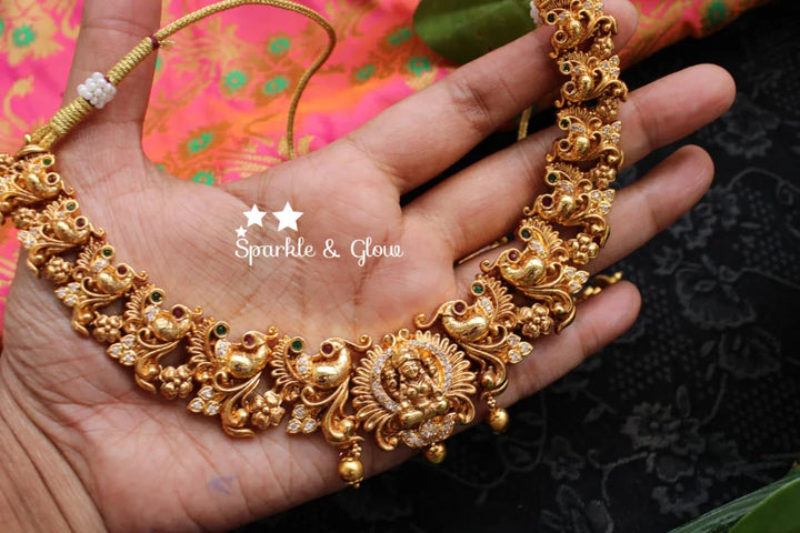 Gold alike polished peacock and lakshmi carved necklace - Sparkle and Glow