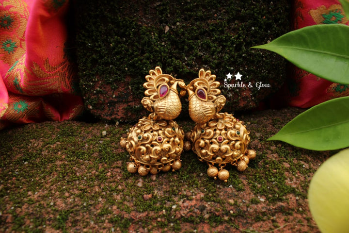 Peacock studded intricately carved jhumukas