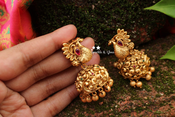 Peacock studded intricately carved jhumukas