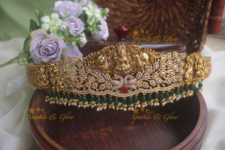 Gold alike AD stone beautiful intricately carved peacock lakshmi hipbelt with green beads