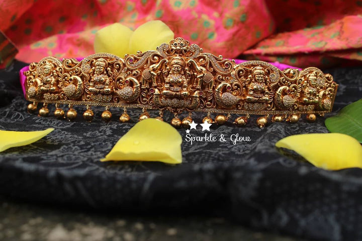 Gold alike polished carved intricately with Lakshmi , peacock and elephant hip belt