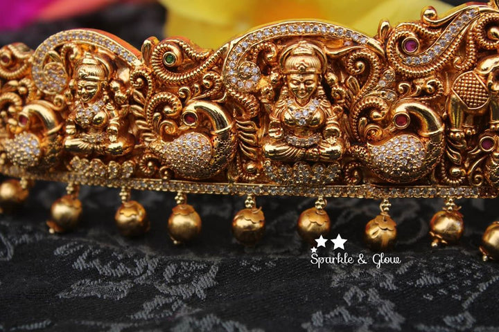 Gold alike polished carved intricately with Lakshmi , peacock and elephant hip belt
