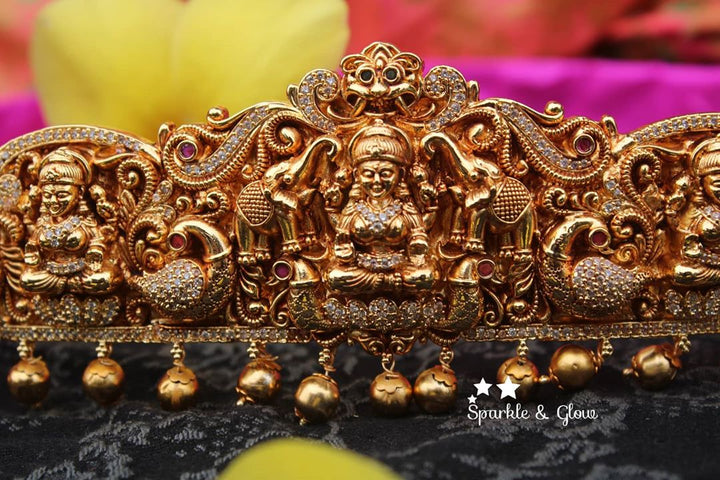 Gold alike polished carved intricately with Lakshmi , peacock and elephant hip belt