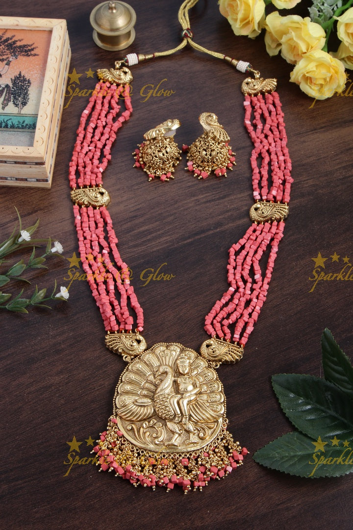 Intricately carved Kartikeyan pendent light coral beads haram