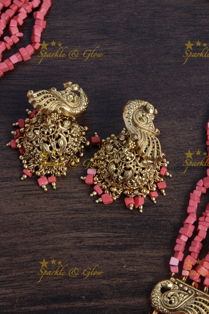Intricately carved Kartikeyan pendent light coral beads haram
