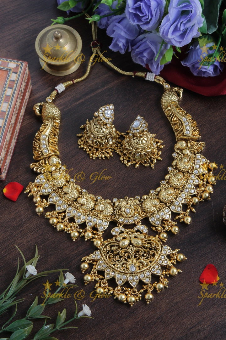 Intricately carved peacock necklace with gold beads