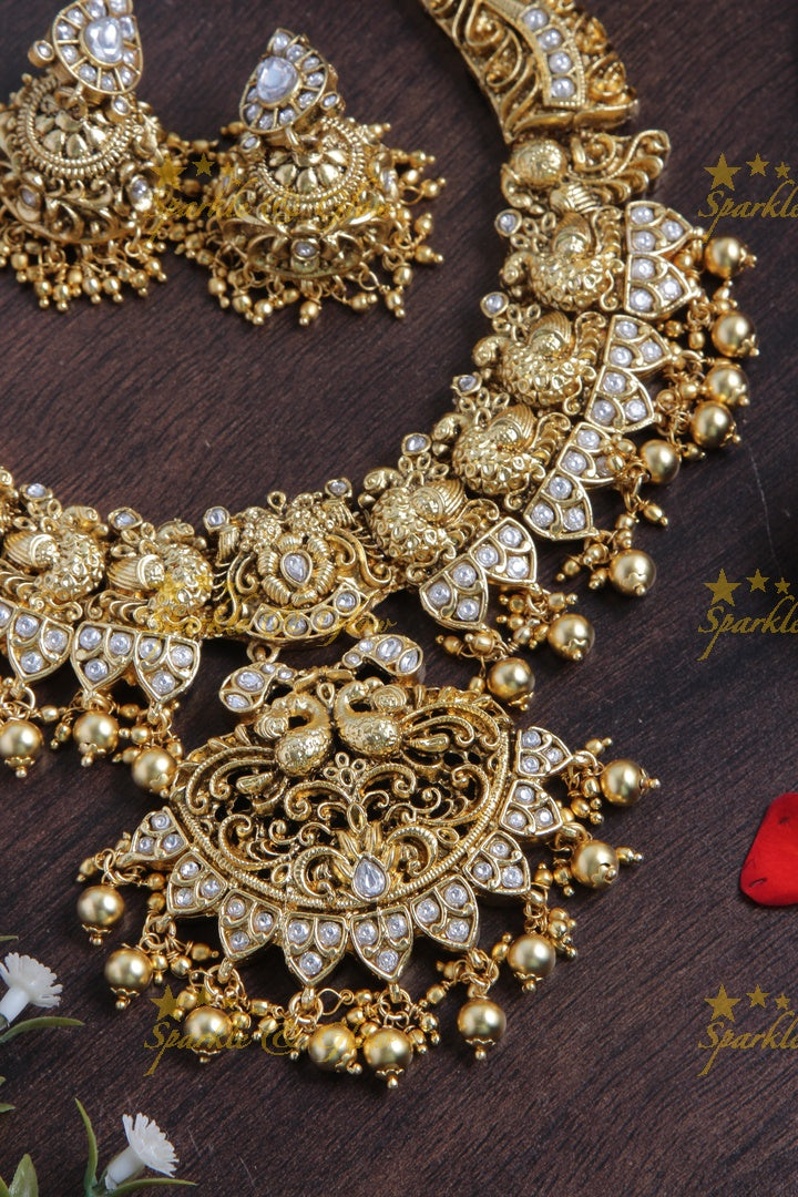 Intricately carved peacock necklace with gold beads