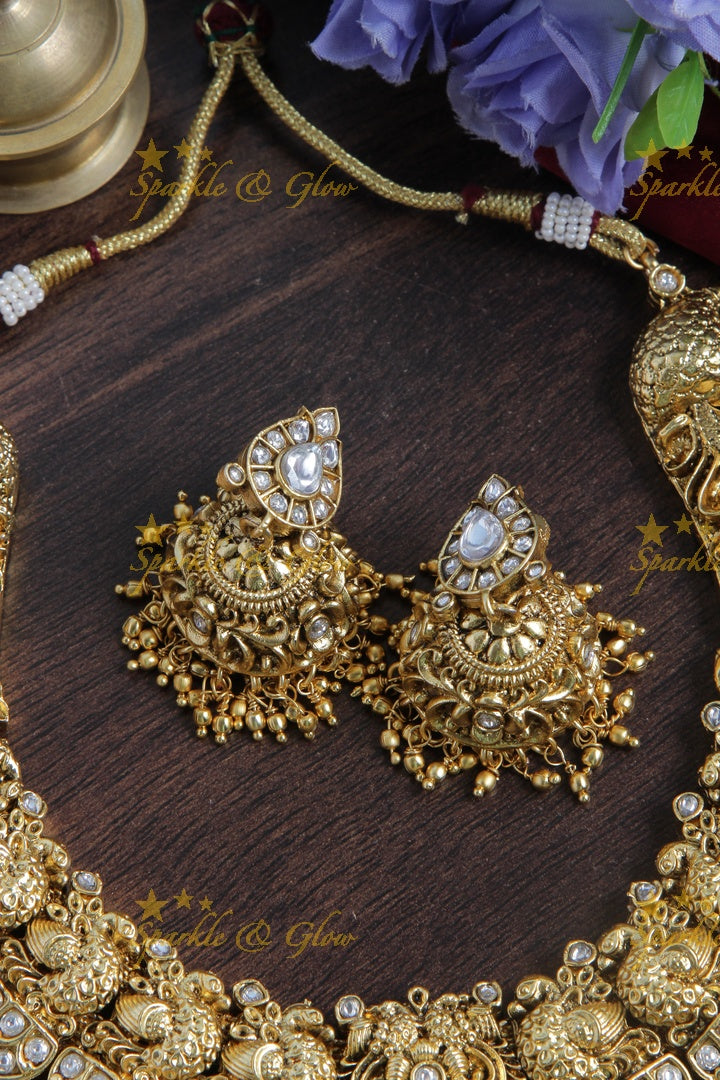 Intricately carved peacock necklace with gold beads