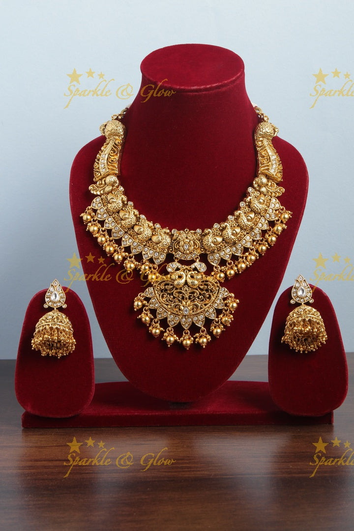 Intricately carved peacock necklace with gold beads