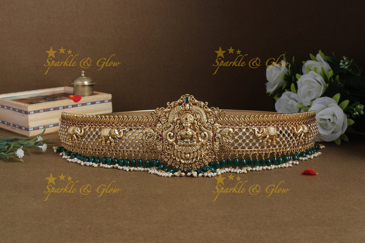 Glittering gold alike lakshmi and elephant carved hipbelt with green beads