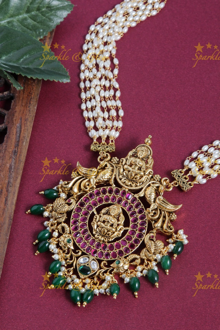 Gold alike rice pearl long necklace with intricately carved lakhsmi pendent with green beads