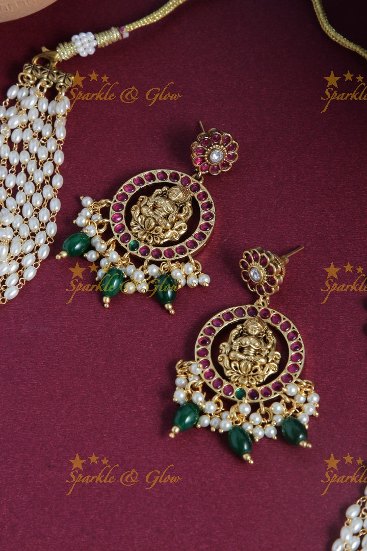 Gold alike rice pearl long necklace with intricately carved lakhsmi pendent with green beads