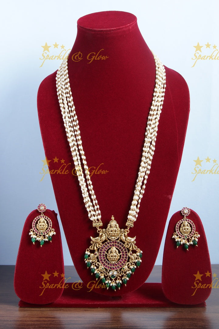 Gold alike rice pearl long necklace with intricately carved lakhsmi pendent with green beads