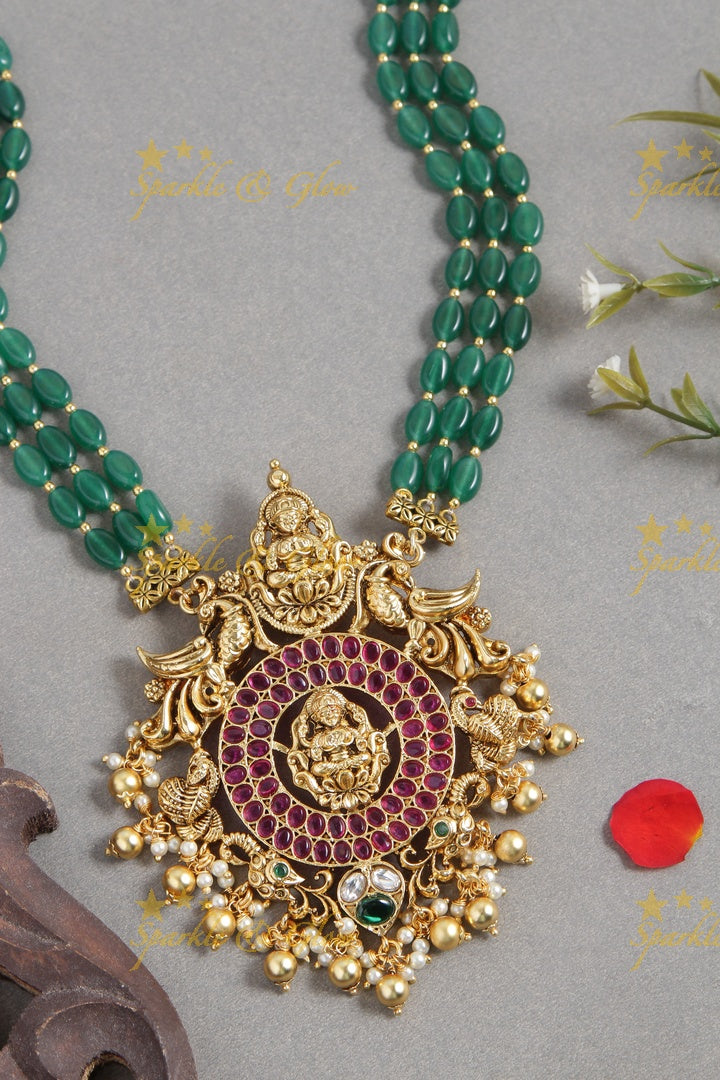 Gold alike green green bead long necklace with intricately carved lakhsmi pendent with gold beads