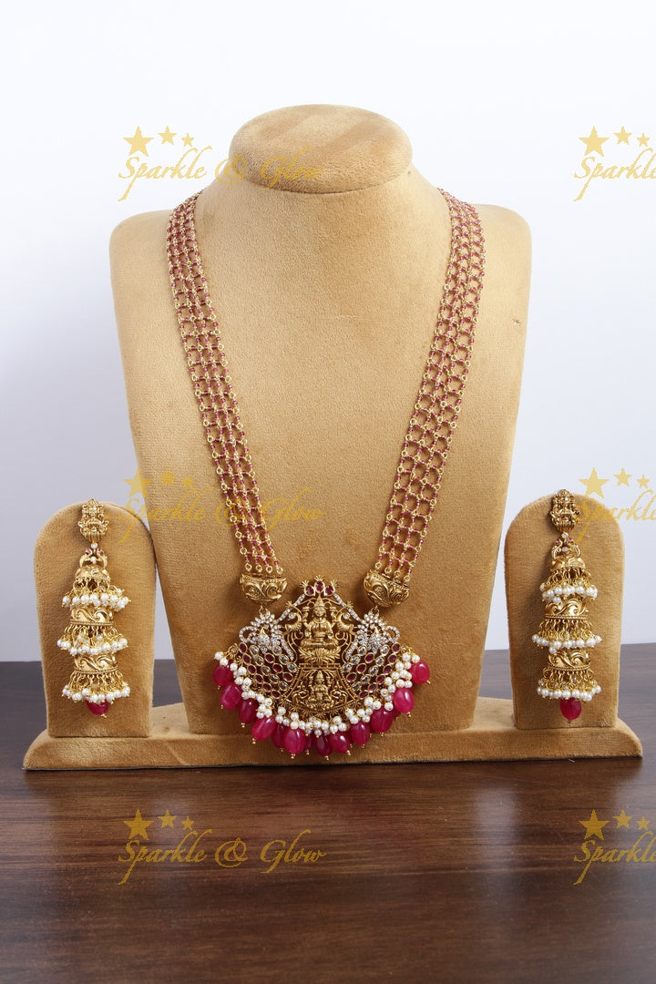 Elegant layered Lakshmi haram with green beads and beautiful step jhumukas