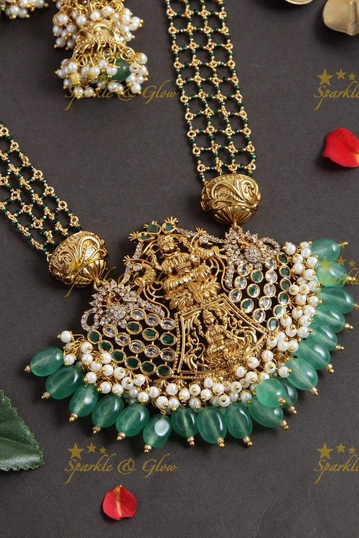 Elegant layered Lakshmi haram with green beads and beautiful step jhumukas