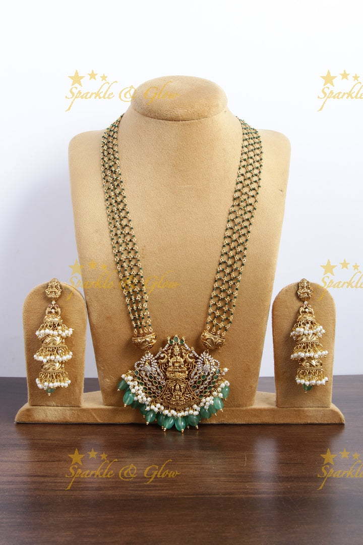 Elegant layered Lakshmi haram with green beads and beautiful step jhumukas
