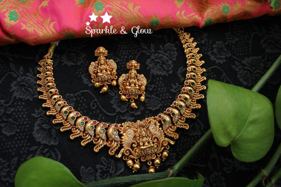 Gold alike polished peacock and lakshmi carved necklace - Sparkle and Glow