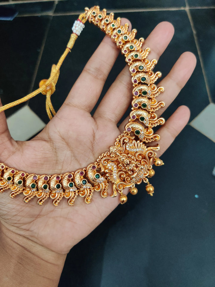 Gold alike polished peacock and lakshmi carved necklace - Sparkle and Glow