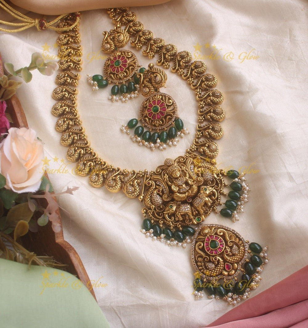 Elegant gold alike Jadau Lakshmi and peacock carved long necklace with green beads - Sparkle and Glow