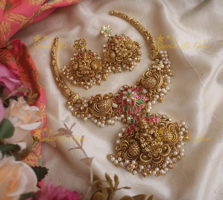 Beautiful Lakshmi peacock and floral design jadau short necklace with pink green and white stones and pearls