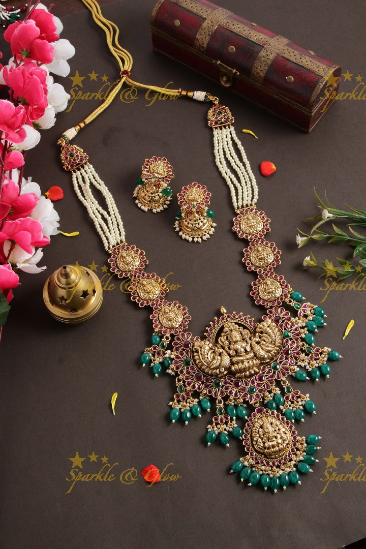 Grand Lakshmi peacock long necklace with multi layer pearl chain red colour stones and green beads - Sparkle and Glow