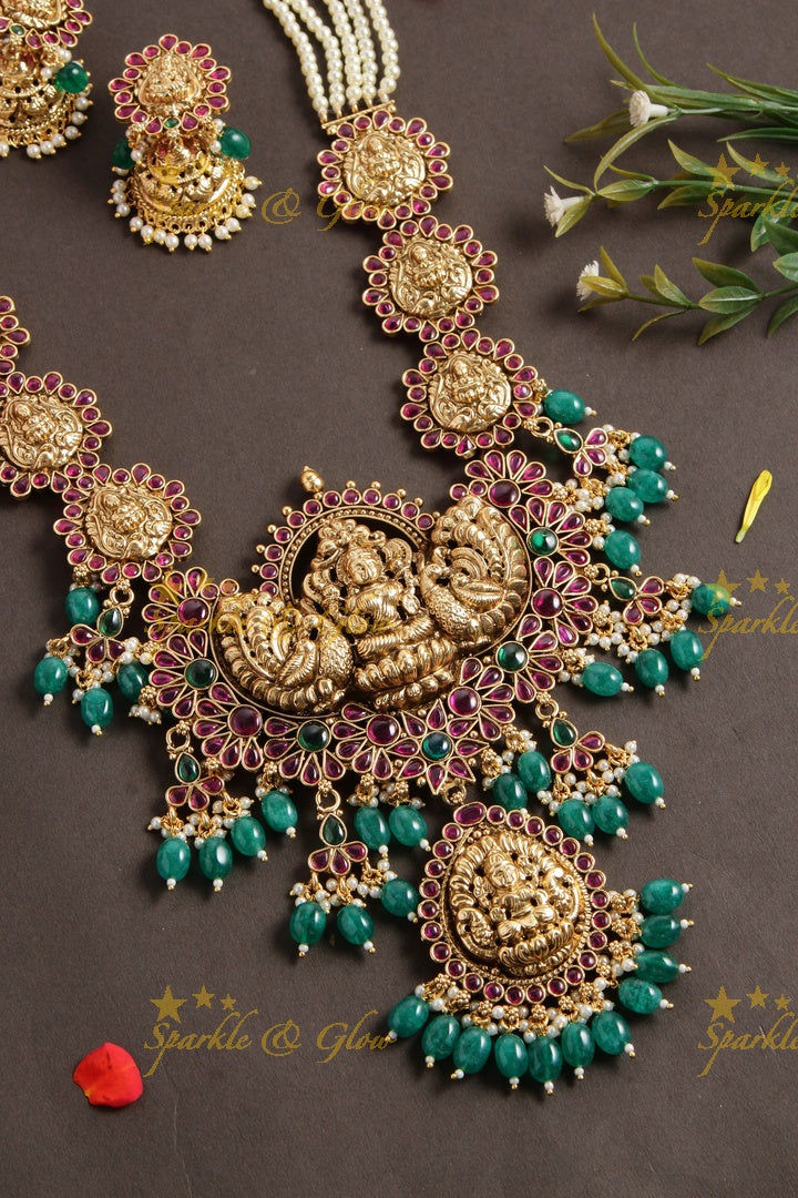 Grand Lakshmi peacock long necklace with multi layer pearl chain red colour stones and green beads - Sparkle and Glow