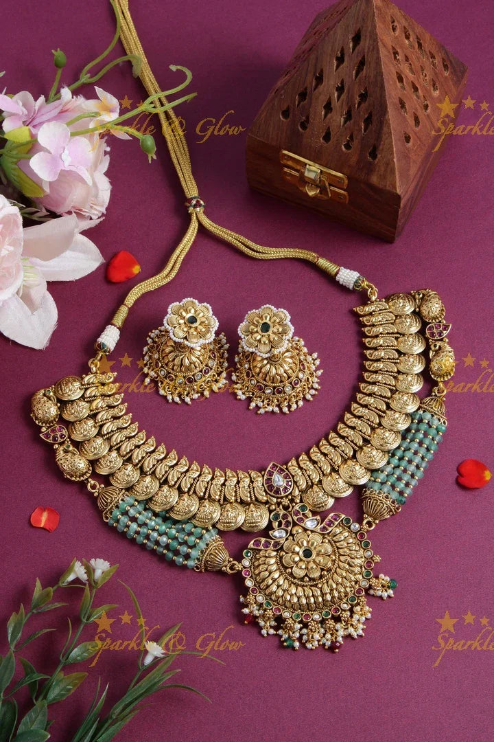 Gold alike Lakshmi coin and peacock short necklace with layered mint green beads - Sparkle and Glow