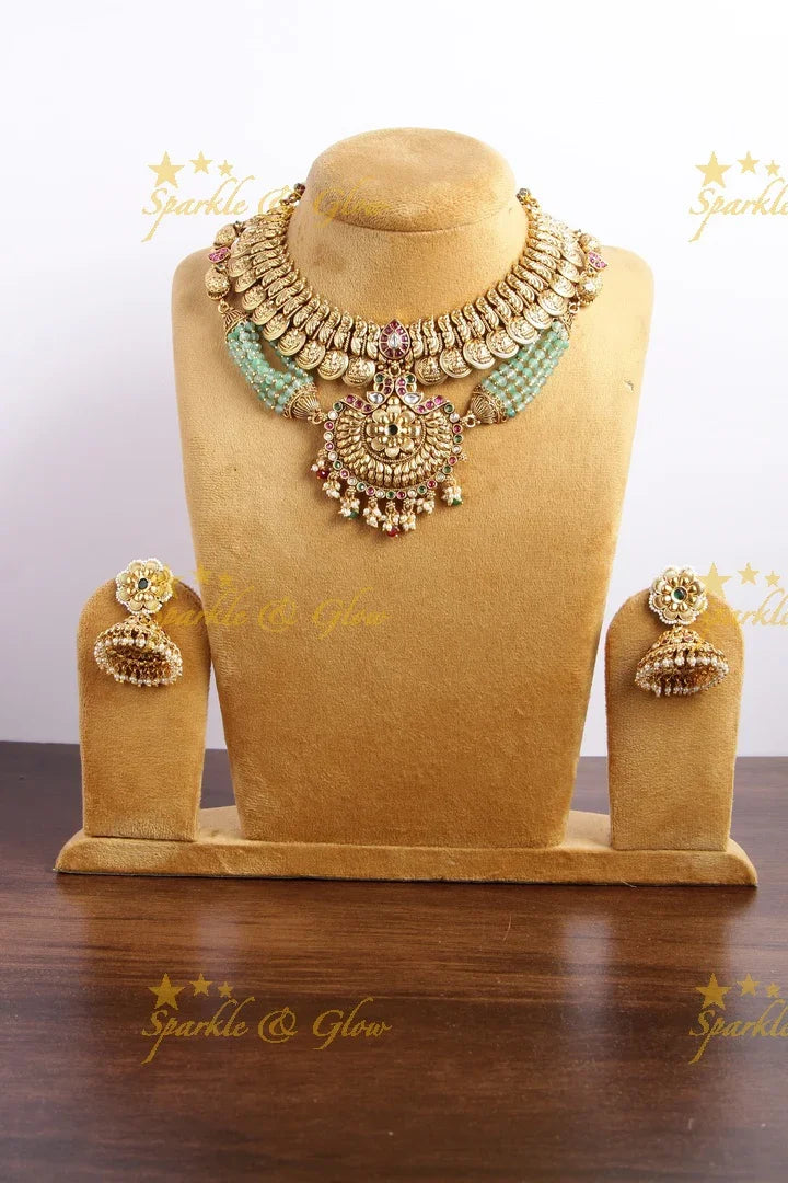 Gold alike Lakshmi coin and peacock short necklace with layered mint green beads - Sparkle and Glow