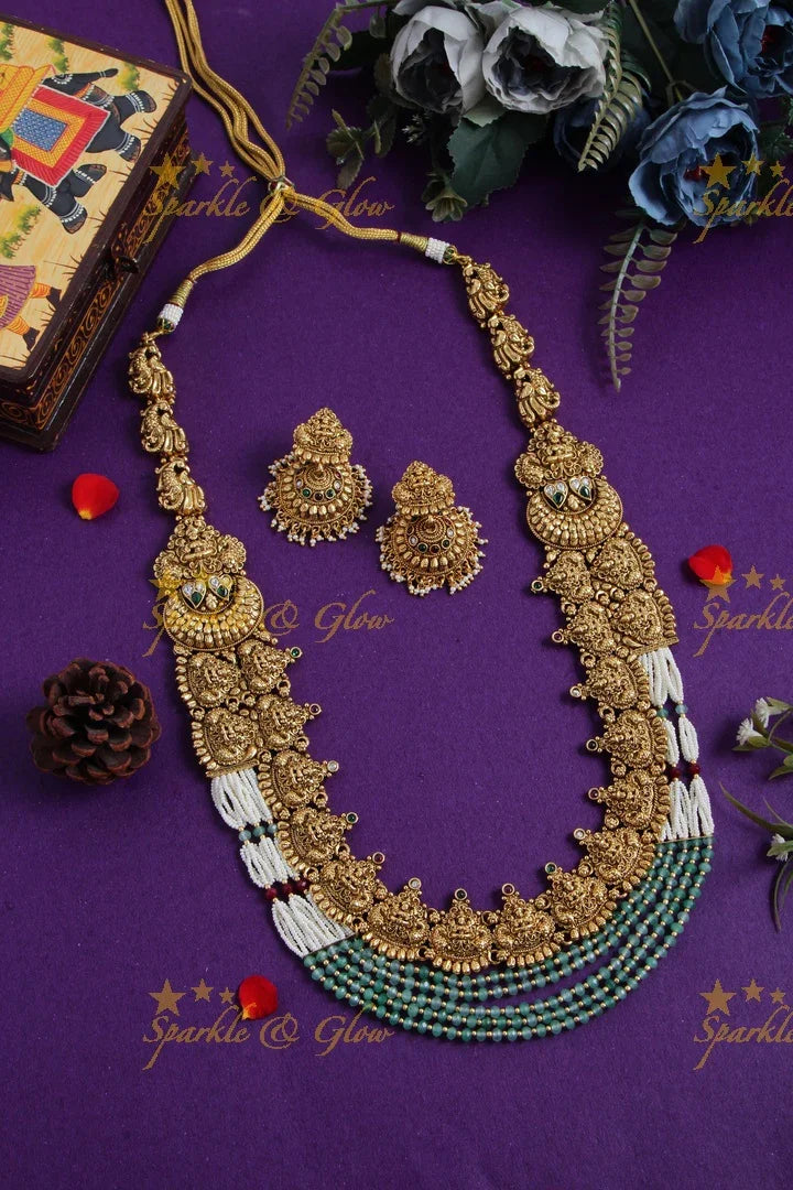 Grand gold alike lakshmi peacock carved long necklace with sea blue beads and pearls - Sparkle and Glow