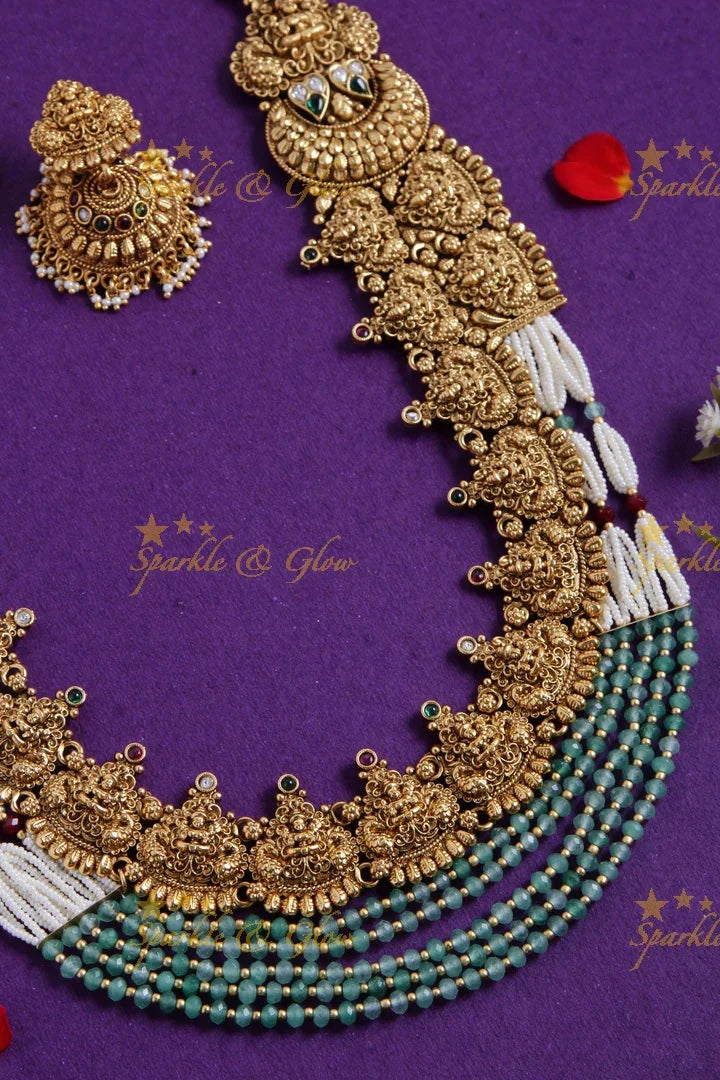 Grand gold alike lakshmi peacock carved long necklace with sea blue beads and pearls - Sparkle and Glow