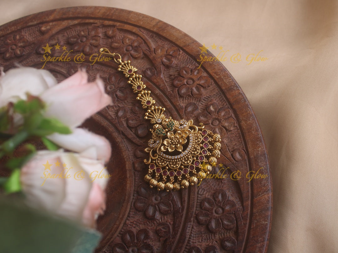 Peacock maang tikka with cz stones ruby emerald and gold beads