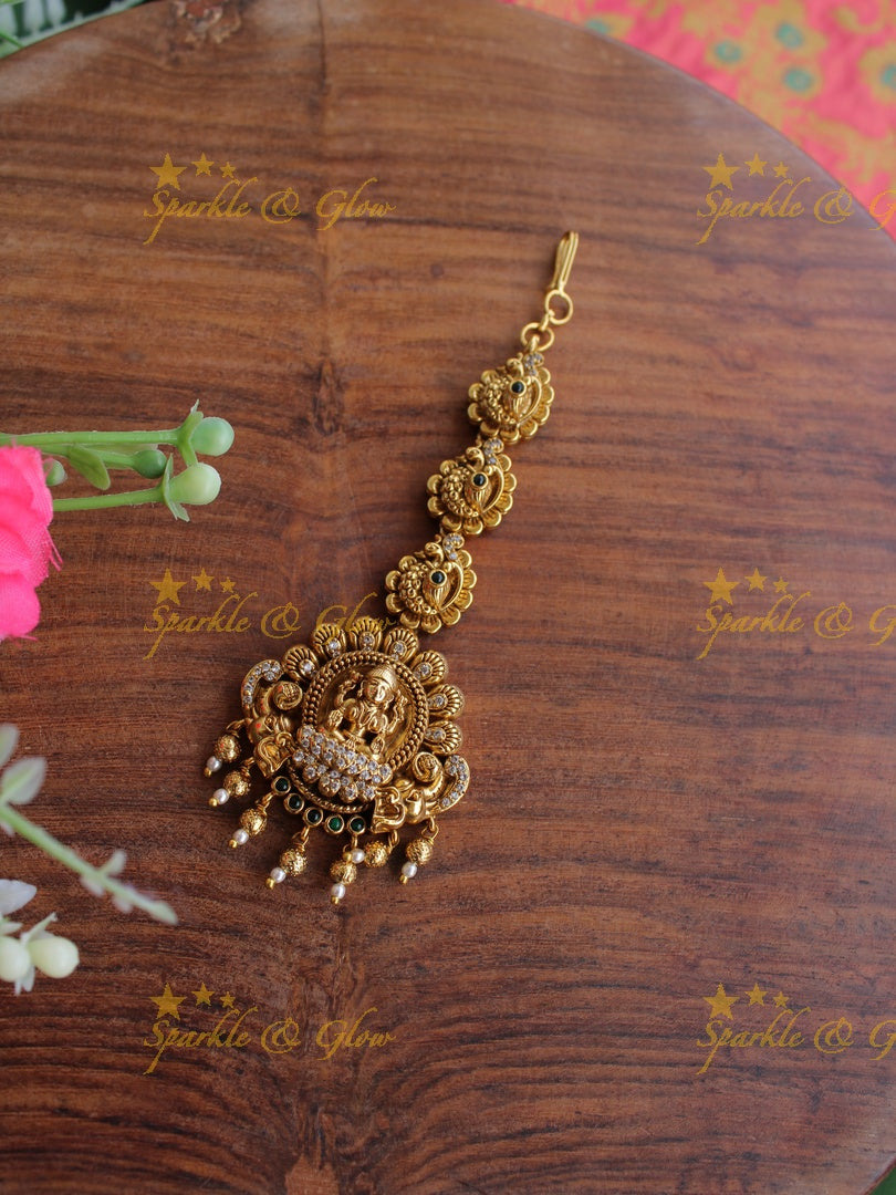 Gold alike Lakshmi peacock maang tikka with cz stones emerald and gold beads