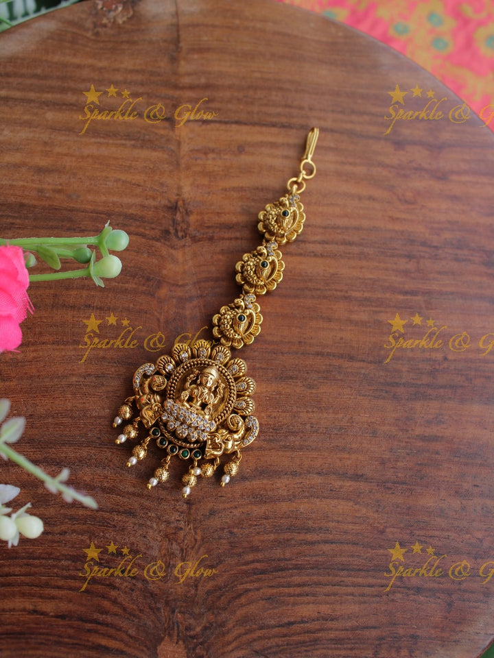 Gold alike Lakshmi peacock maang tikka with cz stones emerald and gold beads