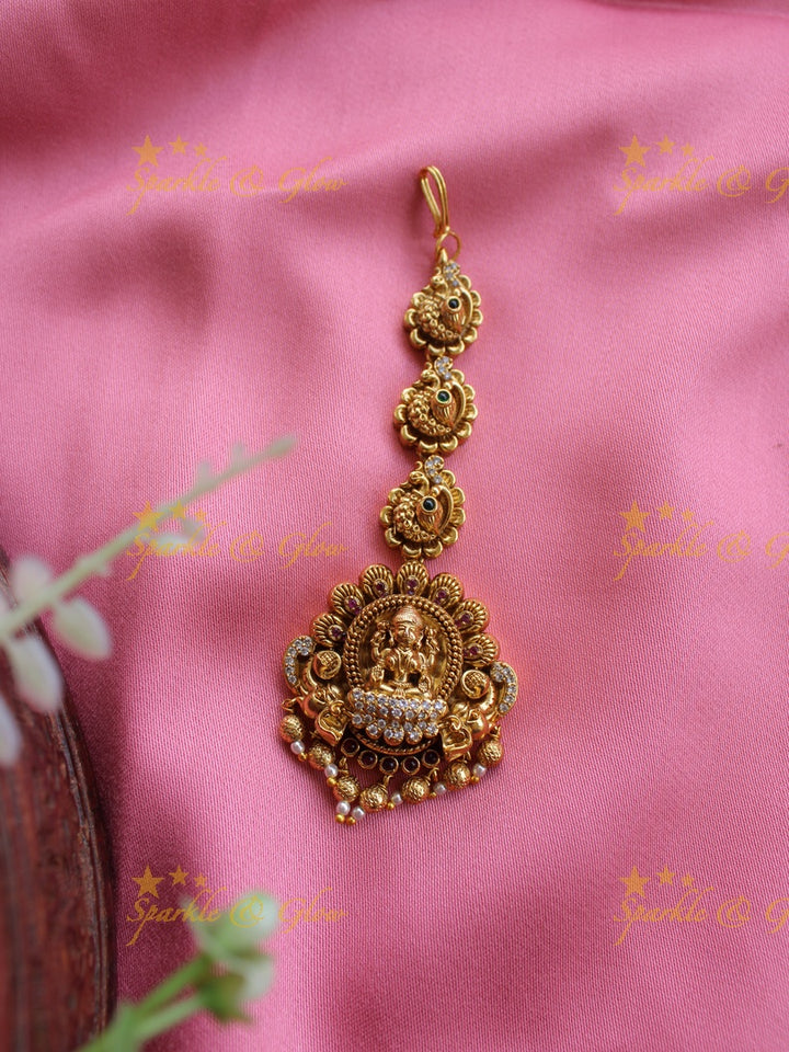 Gold alike Lakshmi peacock maang tikka with cz stones emerald and gold beads