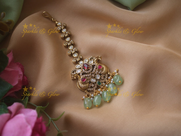 Peacock and floral design victorian maang tikka with red stones and green beads