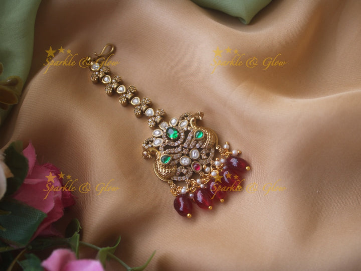 Peacock and floral design victorian maang tikka with green stones and red beads