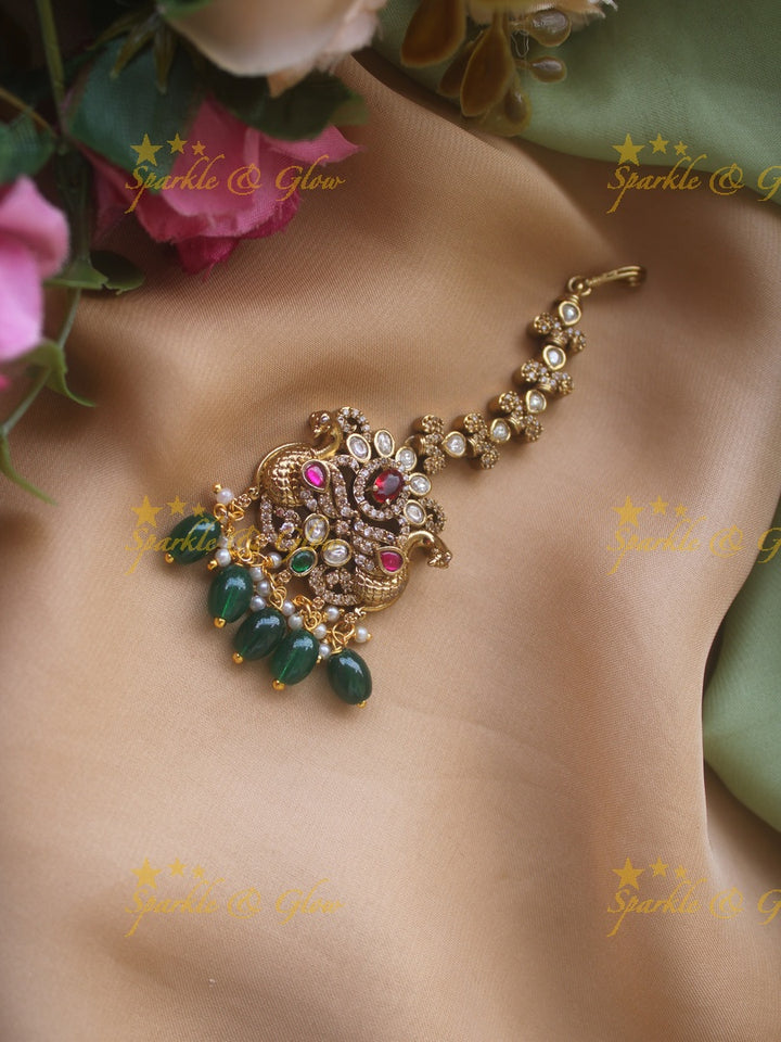 Peacock and floral design victorian maang tikka with green stones and red beads