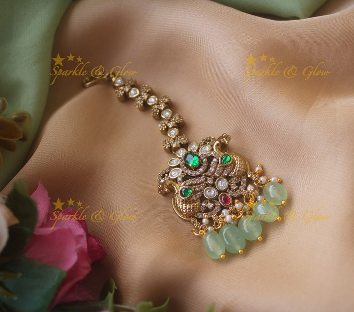 Peacock and floral design victorian maang tikka with red stones and green beads