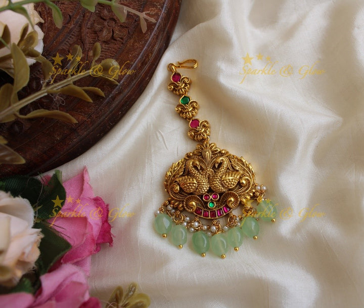Beautiful peacock carved jadau maang tikka with green beads