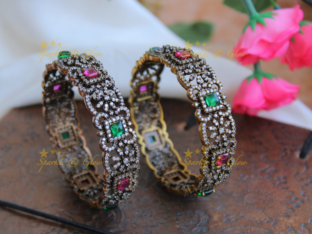 Stunning floral design black finish victorian bangles with ruby and emerald a pair,