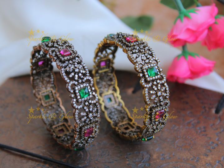 Stunning floral design black finish victorian bangles with ruby and emerald a pair,