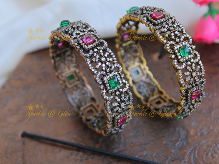 Stunning floral design black finish victorian bangles with ruby and emerald a pair,