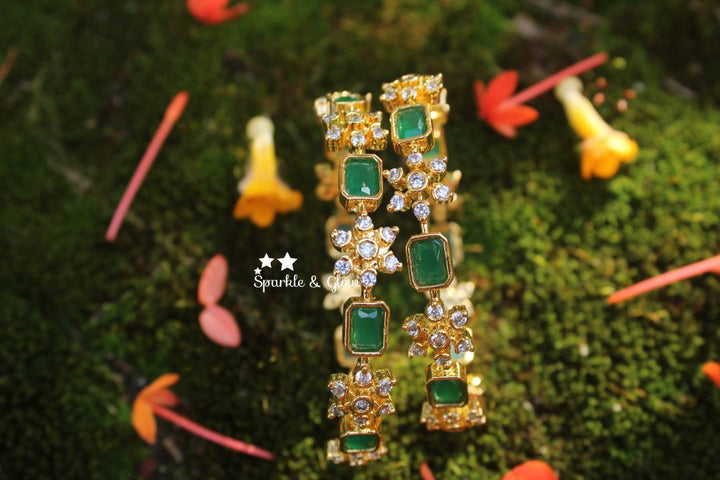 Gold polished snow flake shaped AD stones bangles a pair