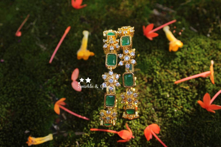 Gold polished snow flake shaped AD stones bangles a pair