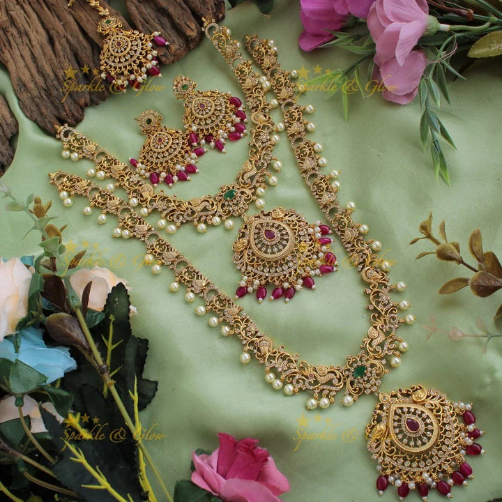 Stunning Premium Matt peacock floral design Necklace set with maang tikka and CZ stones pearls Red beads - Sparkle and Glow